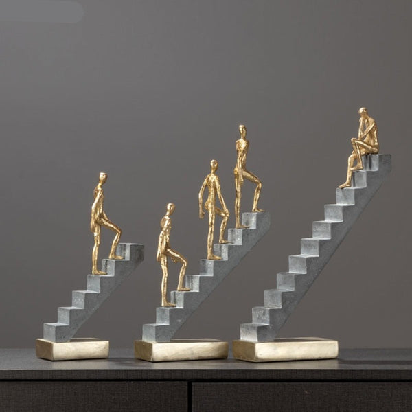 Man Climbing Stairs Statue