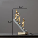 Man Climbing Stairs Statue