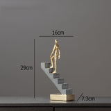 Man Climbing Stairs Statue
